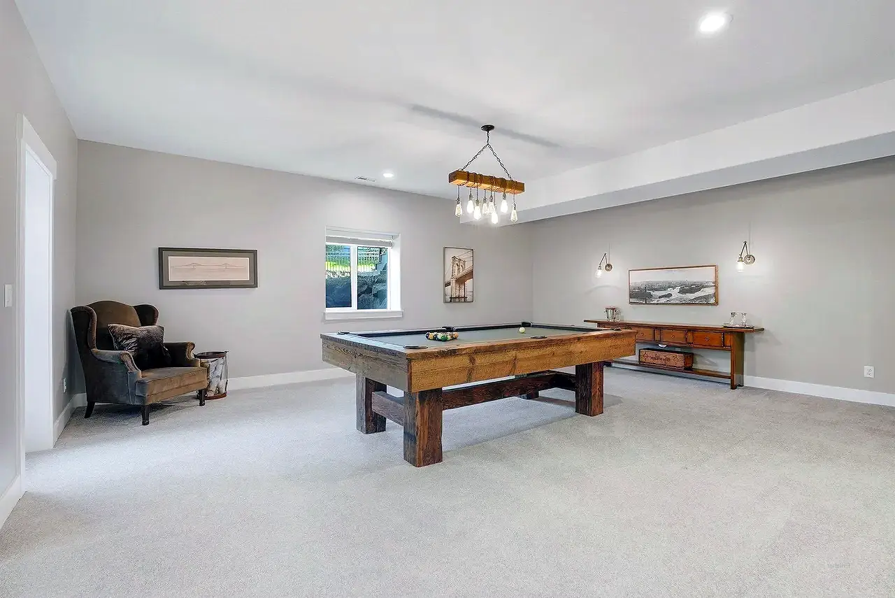 Basement Finishing- basement family room with a pool table