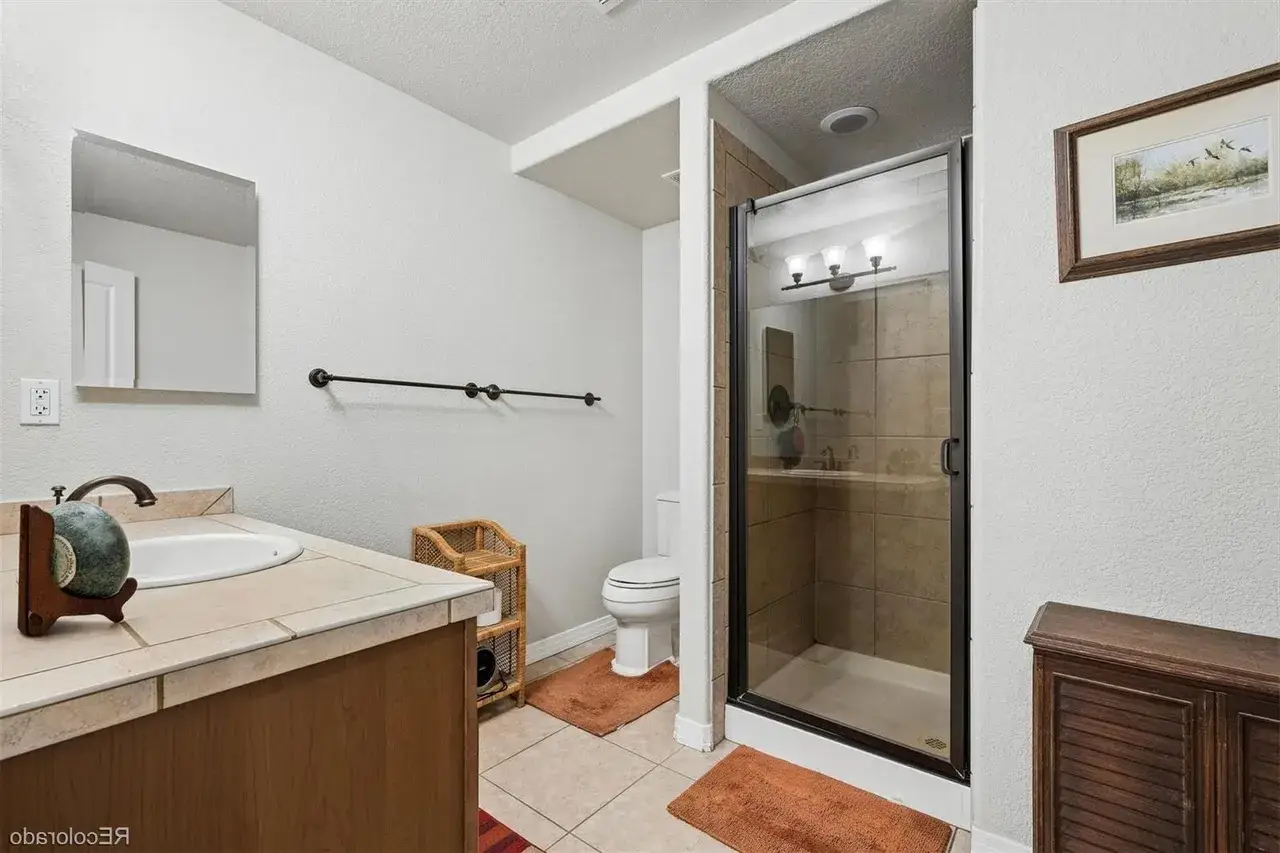 Santaquin Utah Basement Bathroom with a shower insert and a glass door